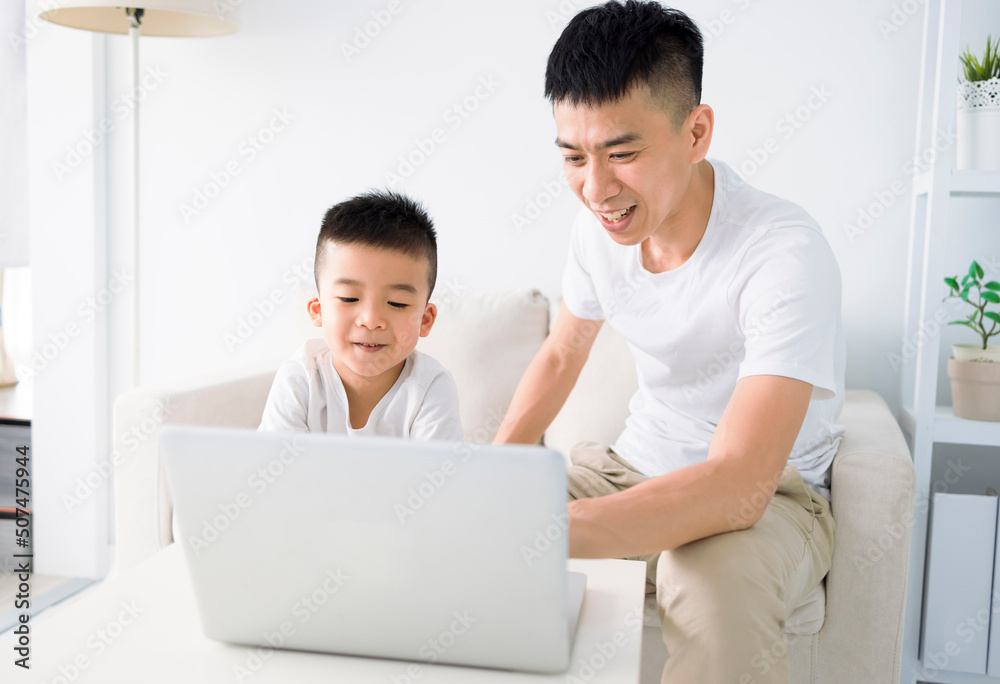 Child educate online. Father help son with home work. Boy in video conference with teacher on laptop at home. Child educate online. Father help son with home work. Boy in video conference with teacher on laptop at home.