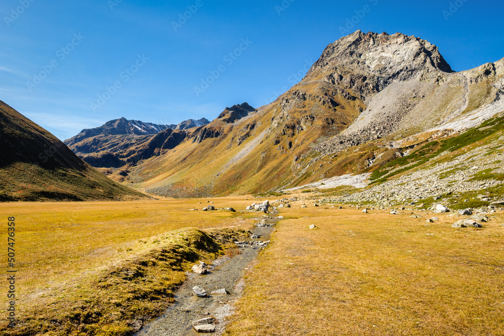 View at the Kaunergrat peaks Seekogel and Rostizkogel from the westside of Lake Rifflsee (largest lake in the Ötztal Alps), above the Pitztal Valley. Here the Rifflbach brook flows into the lake. View at the Kaunergrat peaks Seekogel and Rostizkogel from the westside of Lake Rifflsee (largest lake in the Ötztal Alps), above the Pitztal Valley. Here the Rifflbach brook flows into the lake.