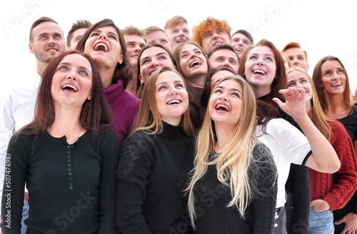 group of happy young people looking up photo