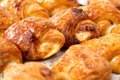 Tasty freshly baked buns on the bakery counter