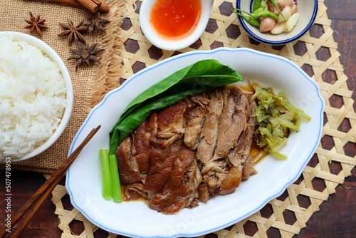 Stewed Pork leg with vegetables and rice at top view on wood table - ( Thai - Chinese style food)
