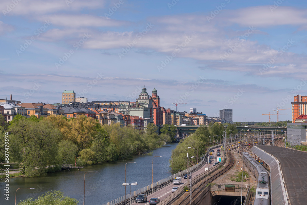 Panorama over the districts Kungsholmen and Vasastan water fronts at the canal Karlbergskanalen. Offices, the street Norra Länken and a rail yard a sunny summer day in Stockholm