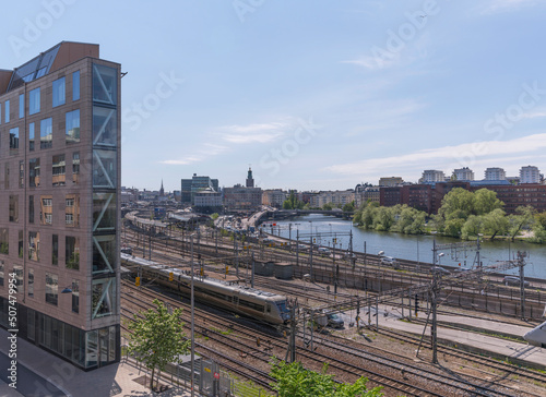 Iron shaped house at the canal Karlbergskanalen. Offices, the street Norra Länken and the central stations rail yard a sunny summer day in Stockholm photo