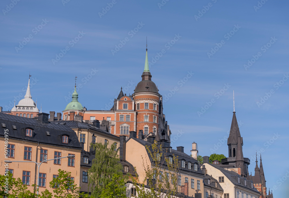 Old houses on a hill in the district Södermalm with tin roofs and dorms a sunny summer day in Stockholm
