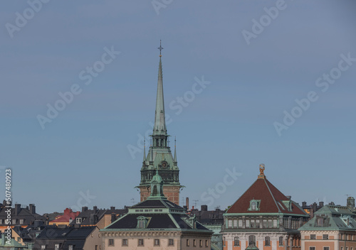 Tin roofs, dorms and the German church in the old town Gamla Stan a sunny summer day in Stockholm