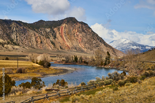 Beautiful landscape of dry and snowy mountains with wide river in foreground © Nicholas J. Klein