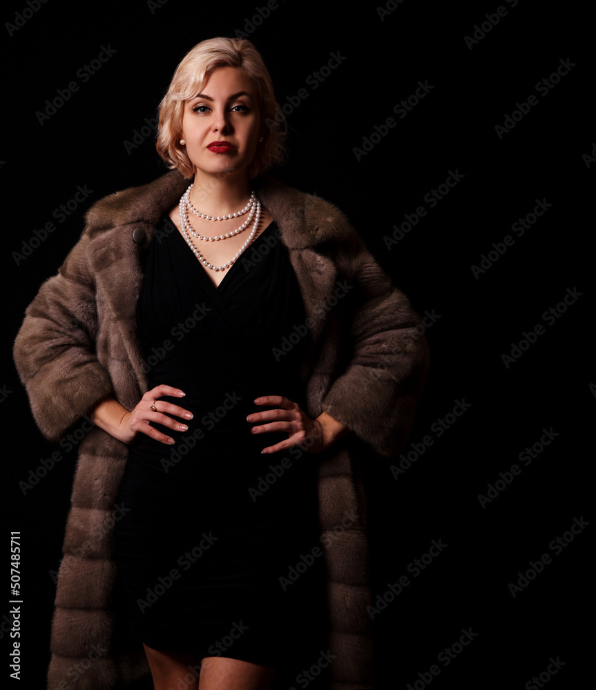 portrait of a young blonde woman in a fur coat in studio portrait of a young blonde woman in a fur coat in studio