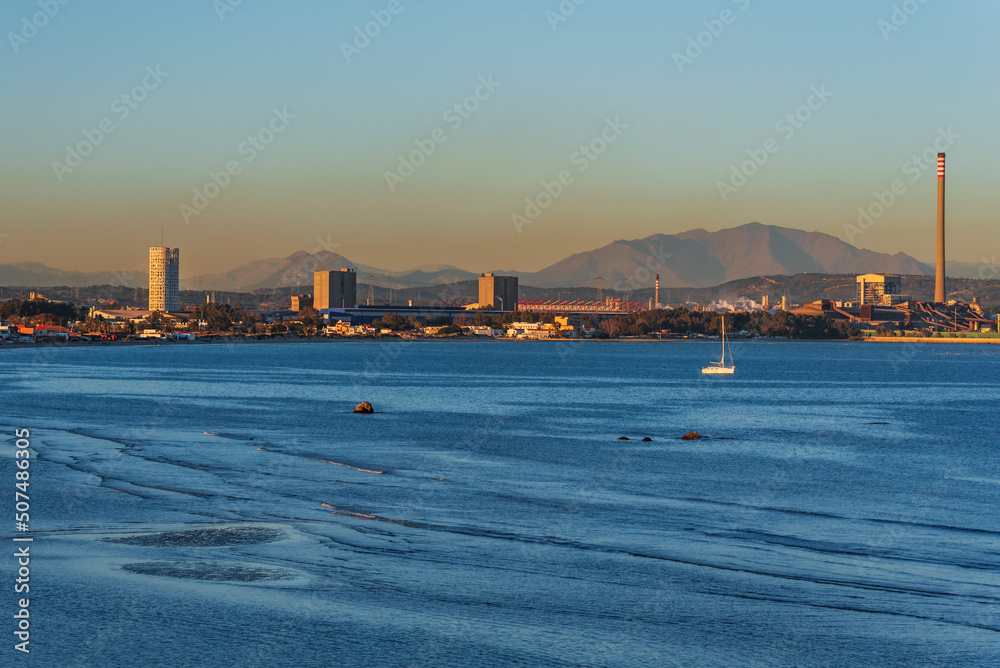 Rinconcillo beach in Algeciras, with a cloud of pollution floating over the industrial zone of Los Barrios, Cádiz.