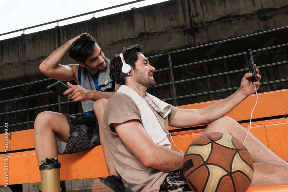 Fototapeta premium Two causian basketball player resting and ralax.