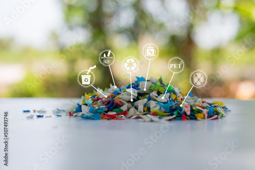 Plastic bottle crushed or Small pieces of cut colorful plastic bottles with Blurred green background. Recycle icon, sustainable icon and Bottle icon. Chemical concept