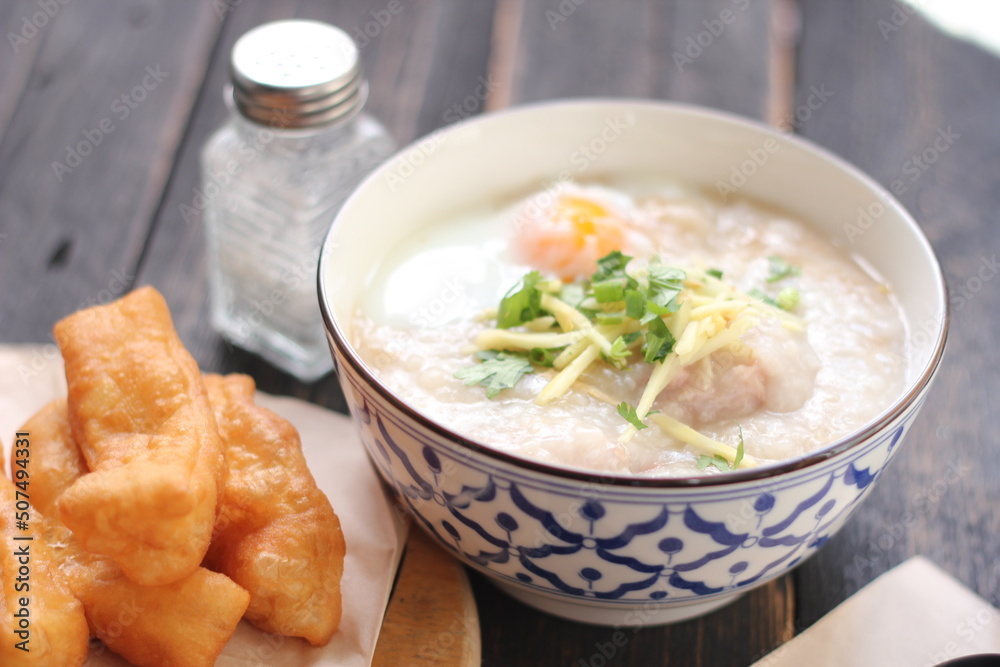 Congee in a Thai-patterned cup and fried dough are Thai food and street food popular to eat in the morning Congee in a Thai-patterned cup and fried dough are Thai food and street food popular to eat in the morning