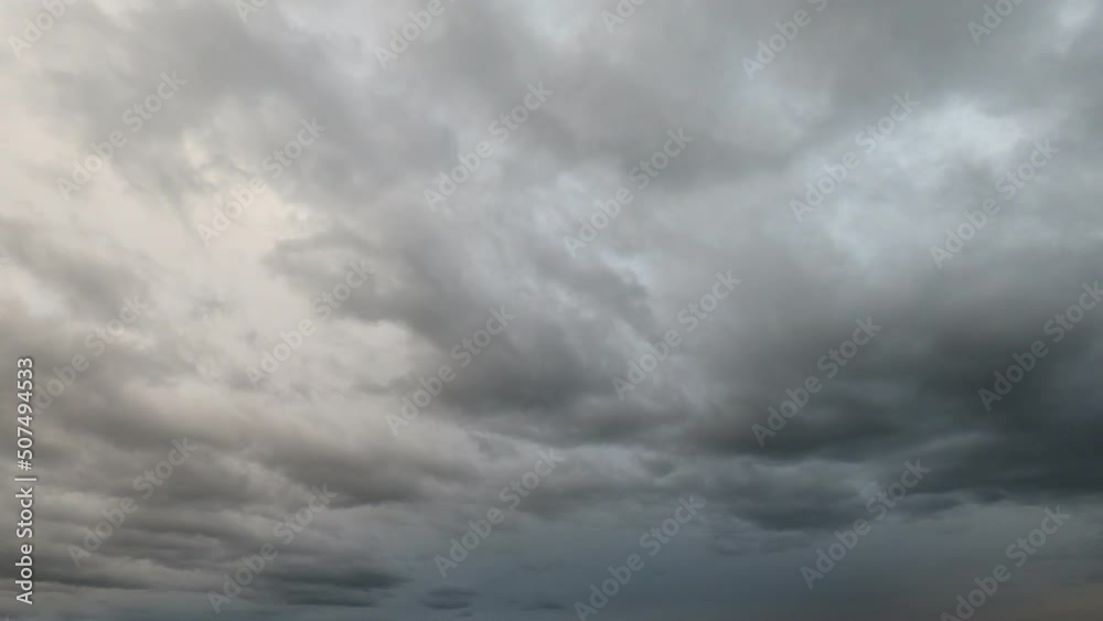 Time -lapse video in dusk with passing, pulling up, pulling off clouds and blue sky