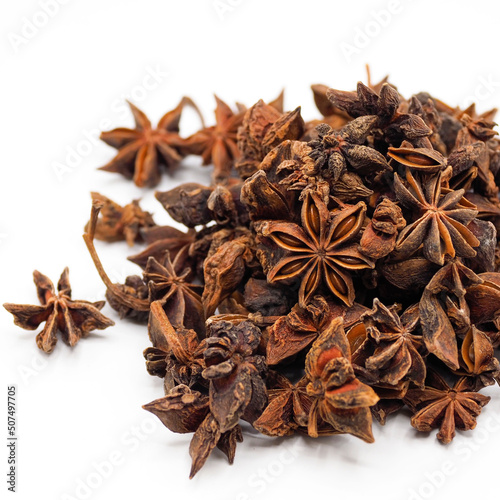 Heap of dried star anise isolated on white background. spot focus.