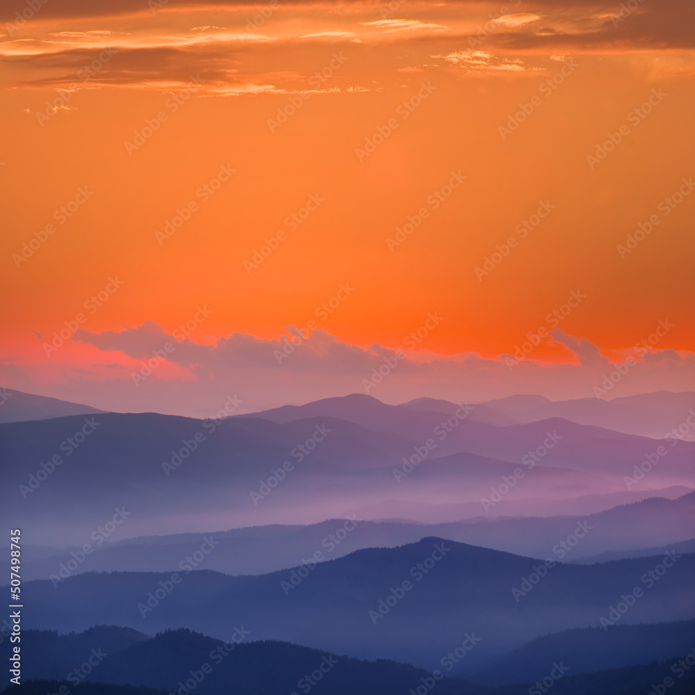 mountain ridge silhouette in blue mist at the twilight, natural mountain travel background