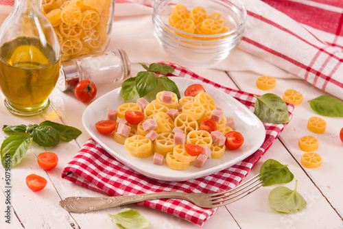 Ruote pasta with tomato and ham.