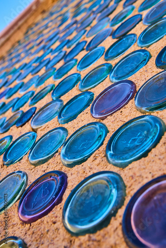 Colorful wall of glass bottles in desert ghost town