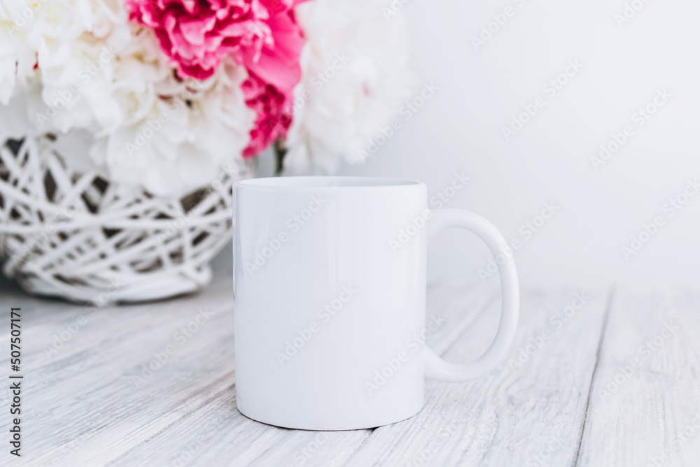 Mock up of white blank coffee mug perfect for your own design or quote with peony flowers on background. Mock up of white blank coffee mug perfect for your own design or quote with peony flowers on background.