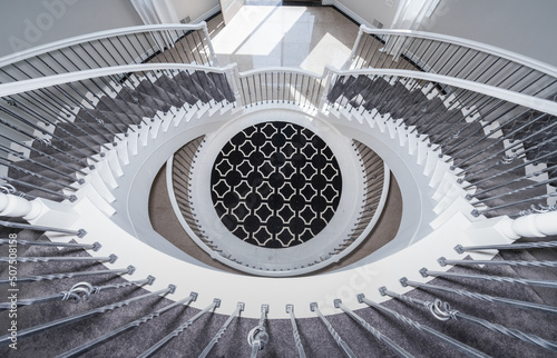 elegant stairs spiral down to lower level photo