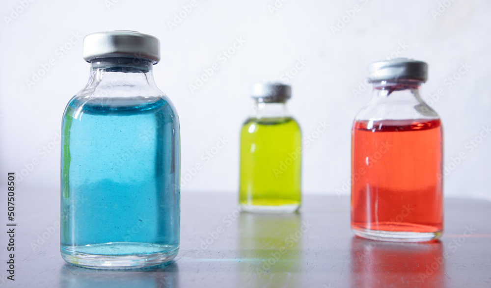 Three vial of color solution are arranged in position. the blue one is focused. Three vial of color solution are arranged in position. the blue one is focused.