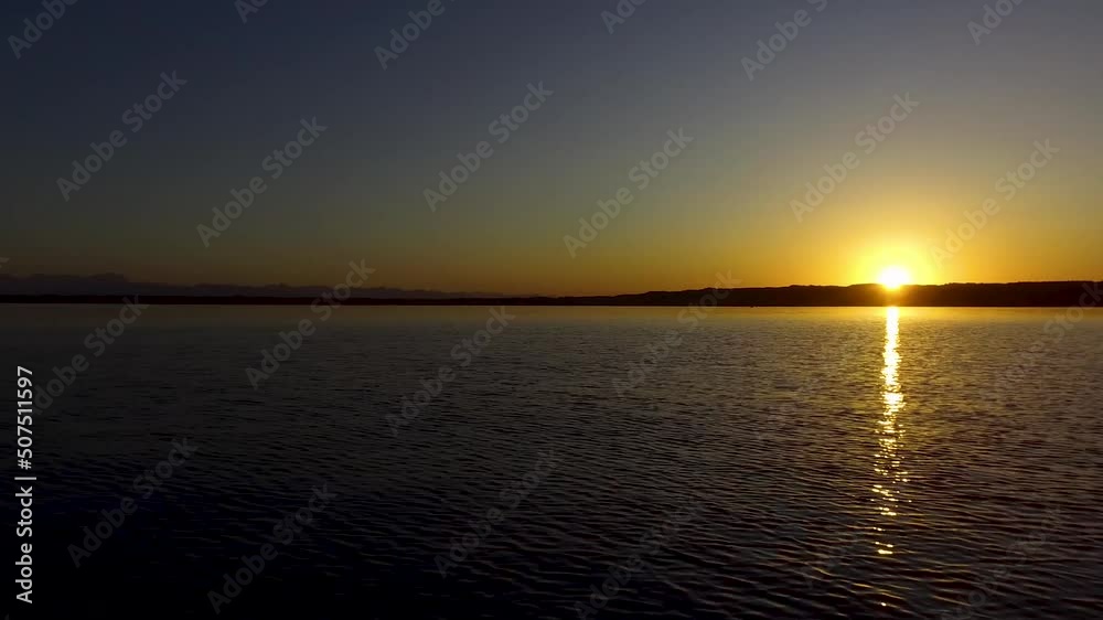 Aerial shot of a beautiful sunset over Starnbergersee with Alps in background in Bayern, Germany Aerial shot of a beautiful sunset over Starnbergersee with Alps in background in Bayern, Germany