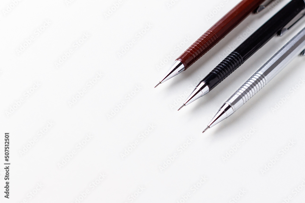 Three mechanical pencils of different sizes on the white background.