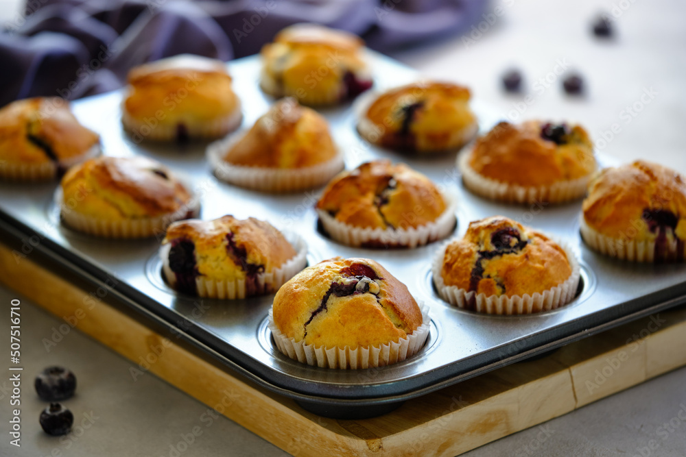 Fragrant lemon muffins with blueberries on a gray background