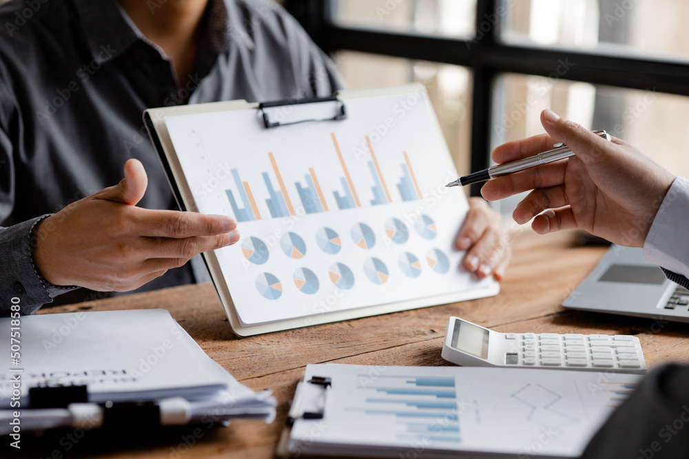 Finance workers are working together to prepare company financial documents for the meeting with management, together they are checking the accuracy of the information. Financial concept. Finance workers are working together to prepare company financial documents for the meeting with management, together they are checking the accuracy of the information. Financial concept.
