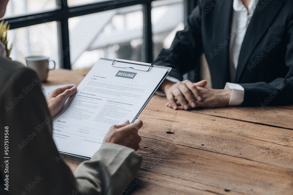 Person submitting resume to interview for a job with a company, Person attending a job interview with a manager to be recruited to the company for the position applied for. Job application concept. Person submitting resume to interview for a job with a company, Person attending a job interview with a manager to be recruited to the company for the position applied for. Job application concept.