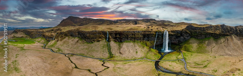 Aerial view of the Seljalandsfoss - located in the South Region in Iceland right by Route 1. Visitors can walk behind it into a small cave. Most popular waterfall in Iceland.
