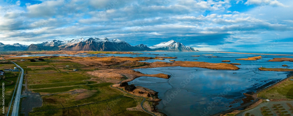 Colorful sunset over the mountains. Fantastic aerial views of the landscape in Iceland with Vestrahorn mountains on the horizon. Colorful sunset over the mountains. Fantastic aerial views of the landscape in Iceland with Vestrahorn mountains on the horizon.