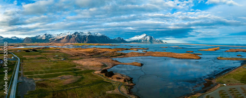 Colorful sunset over the mountains. Fantastic aerial views of the landscape in Iceland with Vestrahorn mountains on the horizon. © Aerial Film Studio