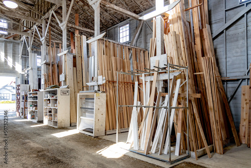 Small town lumberyard with wood for sale in a wooden building.