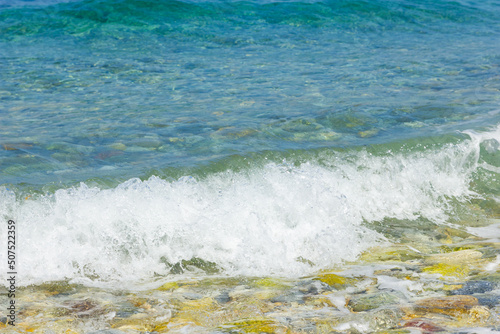 Fototapeta Naklejka Na Ścianę i Meble -  Sea wave close-up. Splashes of water on the sea surface. Summer vacation at the seaside