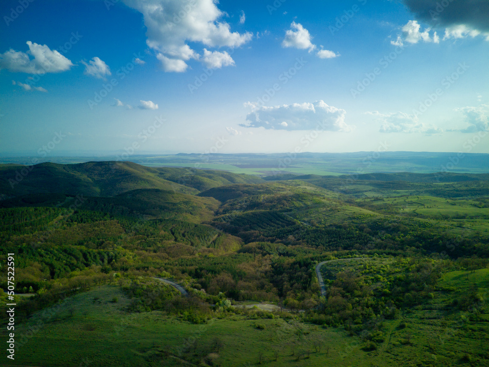 Obraz premium A view from a height of the meadows and slopes of the Balkan Mountains under daylight in Bulgaria