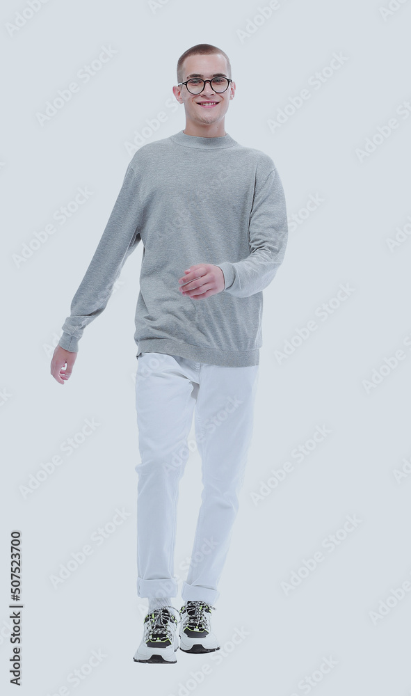 Fototapeta premium in full growth. smiling youngster in glasses goes forward