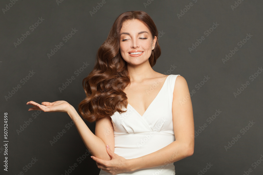 © artmim - Woman with empty open hand. Beautiful model showing palm hand on black background © artmim - Woman with empty open hand. Beautiful model showing palm hand on black background