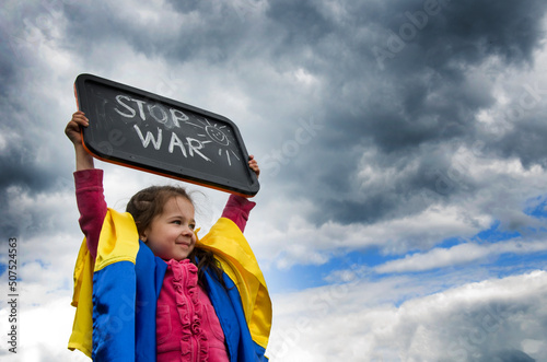 No war against the sky. Child with a slogan against war. Ukrainian child with the slogan stop war. War in Ukraine. Russian aggression against the country. Peace concept.