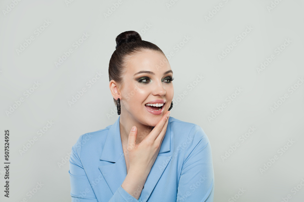 Surprised happy brunette woman with cute smile and trendy makeup looking away over white background Surprised happy brunette woman with cute smile and trendy makeup looking away over white background