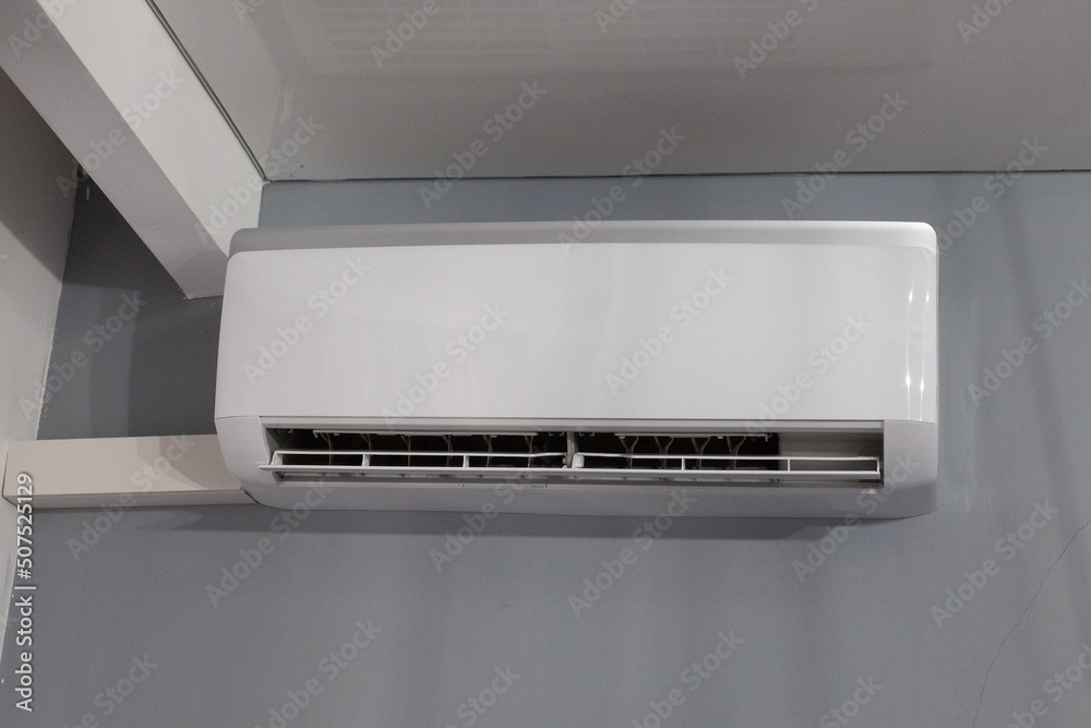 Air conditioner on gray wall room interior background Air conditioner on gray wall room interior background