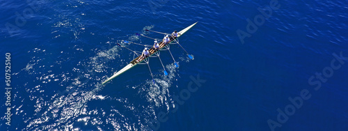 Fotografija Aerial drone top ultra wide panoramic view of sport canoe rowing synchronous tea