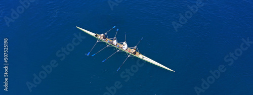 Obraz na płótnie Aerial drone top ultra wide panoramic view of sport canoe rowing synchronous team of athletes competing in deep blue sea w salonie
