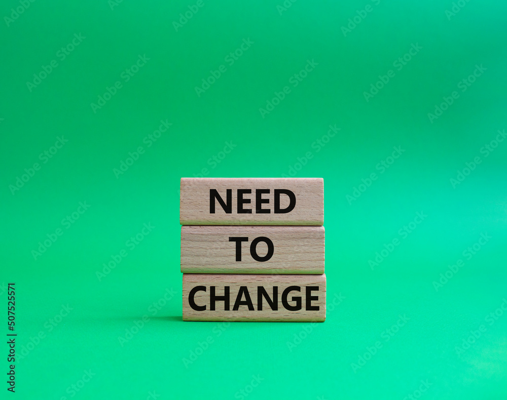 Need to change symbol. Concept words 'Need to change' on wooden blocks. Beautiful green background. Business and Need to change concept. Copy space. Need to change symbol. Concept words 'Need to change' on wooden blocks. Beautiful green background. Business and Need to change concept. Copy space.