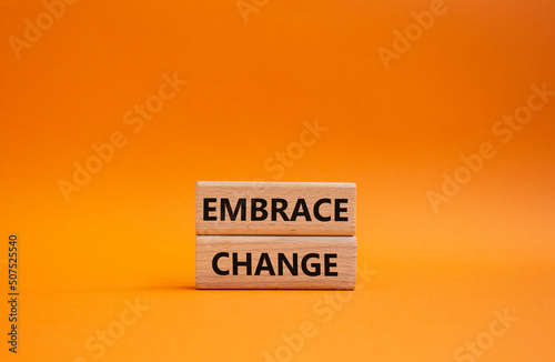 Embrace change symbol. Concept word Embrace change on wooden blocks. Beautiful orange background. Business and Embrace change concept. Copy space photo