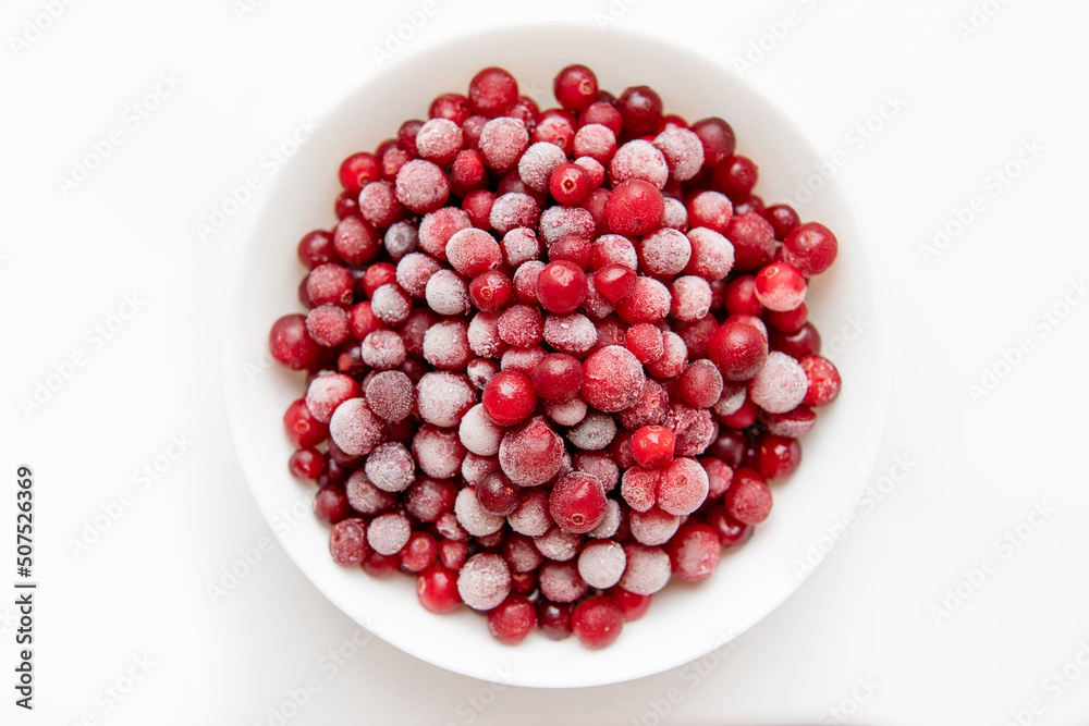 red frozen berries on a white background. cranberries on a white plate close-up.
red frozen berries on a white background. cranberries on a white plate close-up.