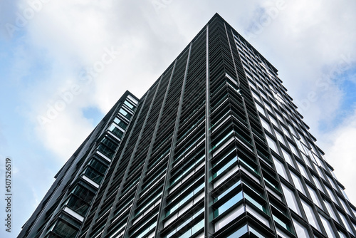 Windows on modern glass and steel skyscraper office building - abstract business background
