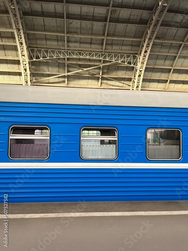 Blue train on the station, trains windows 