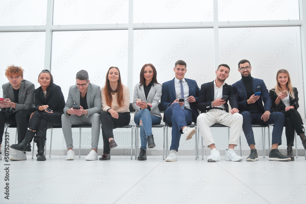 group of young business people waiting in line. group of young business people waiting in line.