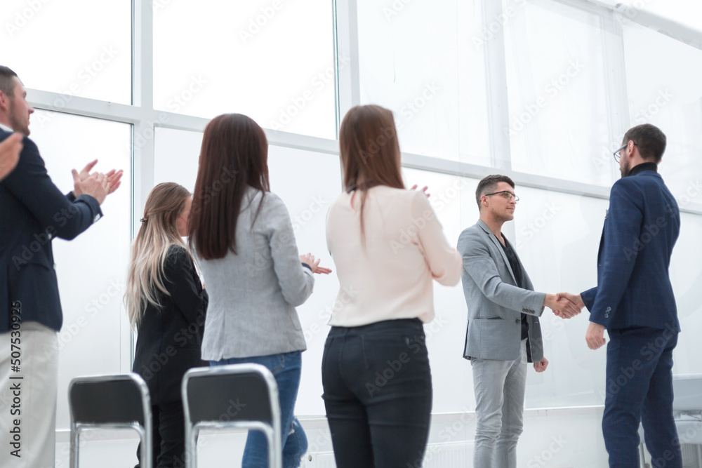 project Manager and business team congratulating the best employee. project Manager and business team congratulating the best employee.