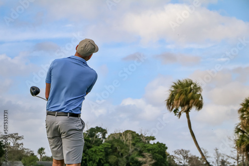 golfer looking after his tee shot