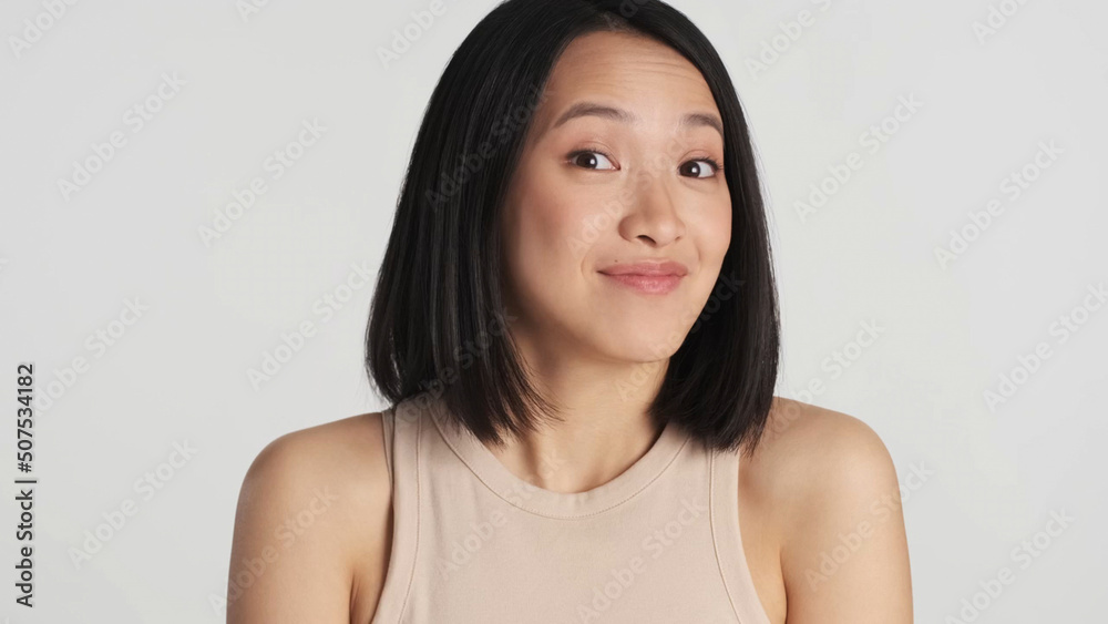 Portrait of Asian looking surprised isolated on white background. Face expression Portrait of Asian looking surprised isolated on white background. Face expression